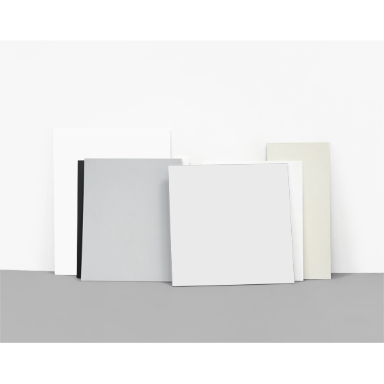 Minimalist still life composition featuring an arranged collection of white, cream, and gray rectangular boards and papers of varying sizes, leaning against a gray surface against a neutral backdrop. The clean geometric arrangement emphasizes subtle tonal variations and the interplay of light across flat surfaces.