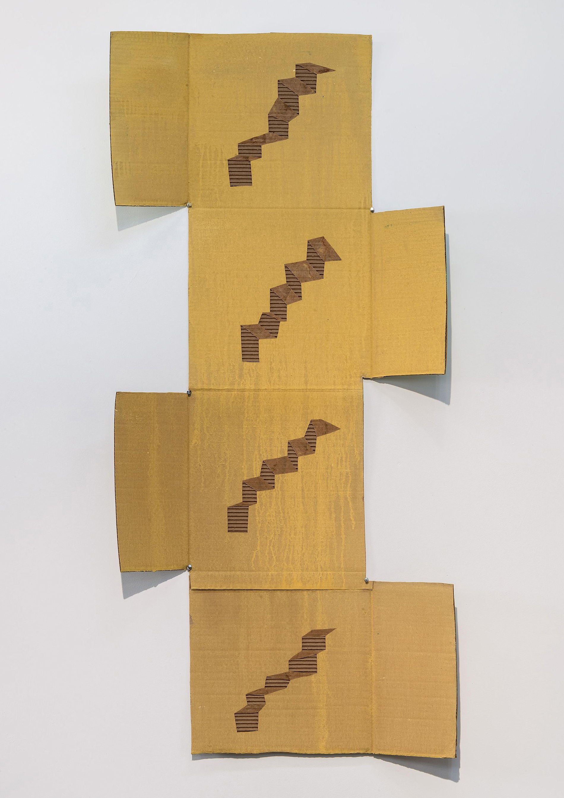 Four tan cardboard panels arranged vertically and offset from each other against a white wall, each featuring a staircase pattern cut through the corrugated material to reveal the layered interior. The cascading geometric forms progress upward across the composition, creating a sense of movement through the dimensional cutouts.