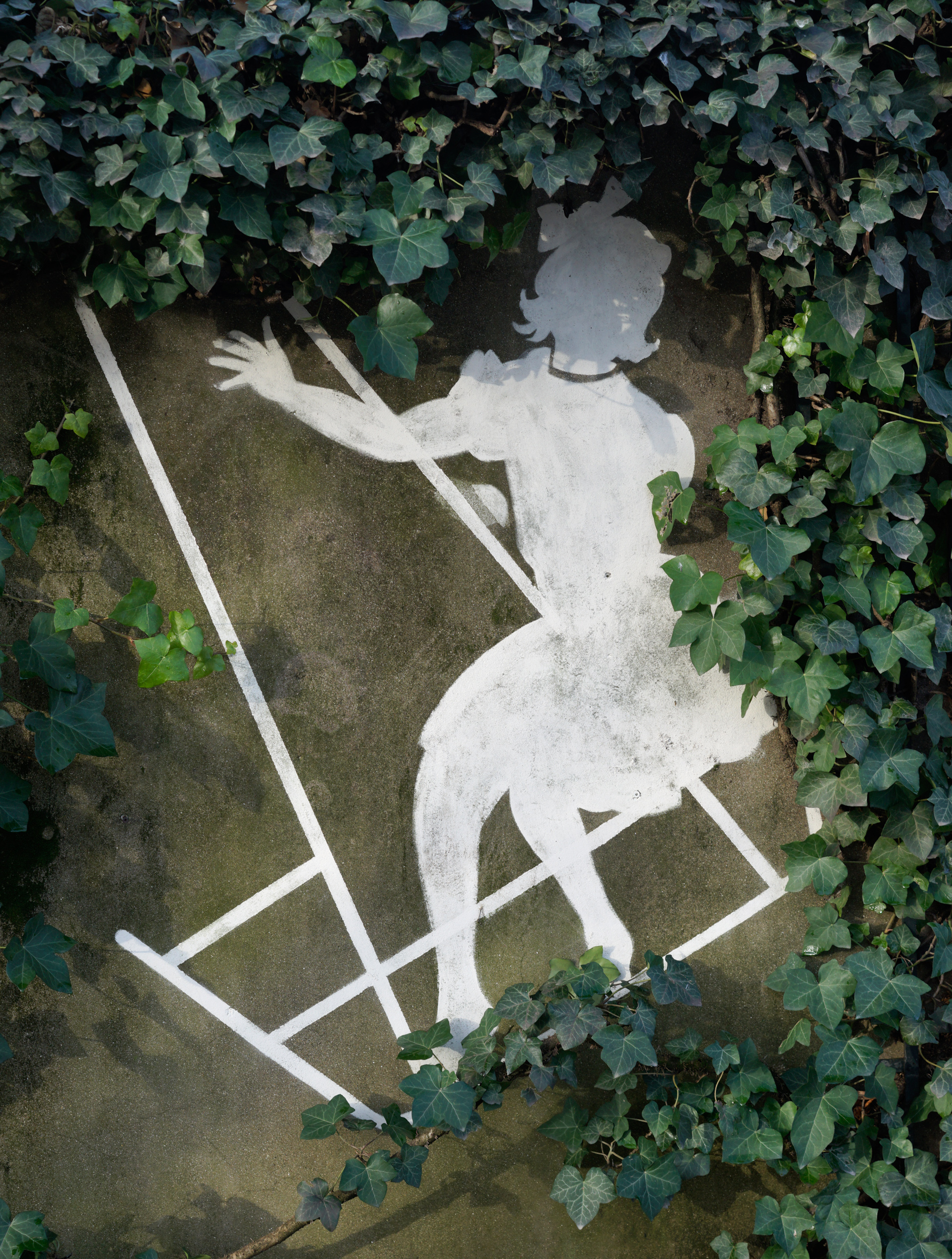 White chalk outline of a reclining female figure drawn on weathered concrete ground, framed by lush green ivy and climbing vines that encroach from the edges, creating a contrast between the geometric human form and organic natural growth.
