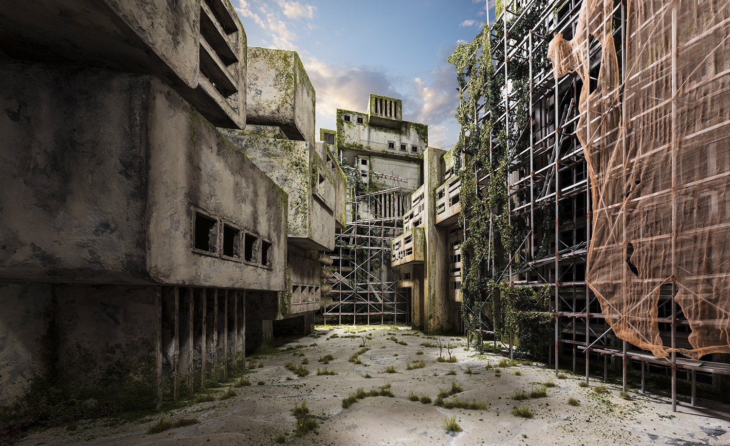 Abandoned concrete buildings with moss-covered facades line a narrow courtyard overgrown with sparse vegetation and sandy ground. Metal scaffolding and safety netting cover the deteriorating structures, while vines climb the weathered walls beneath a partly cloudy sky.