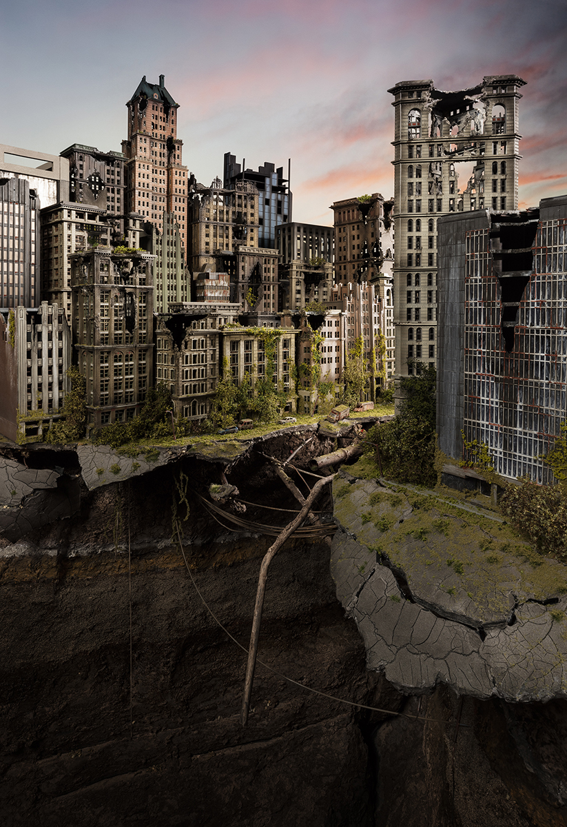 A post-apocalyptic cityscape depicting abandoned skyscrapers overtaken by vegetation and decay, with cracked pavement, rusted debris, and gnarled branches scattered across barren ground in the foreground. Soft golden and pink light illuminates the deteriorating Art Deco and early modernist architecture against a dusky sky, creating a haunting contrast between urban grandeur and nature reclaiming the built environment.