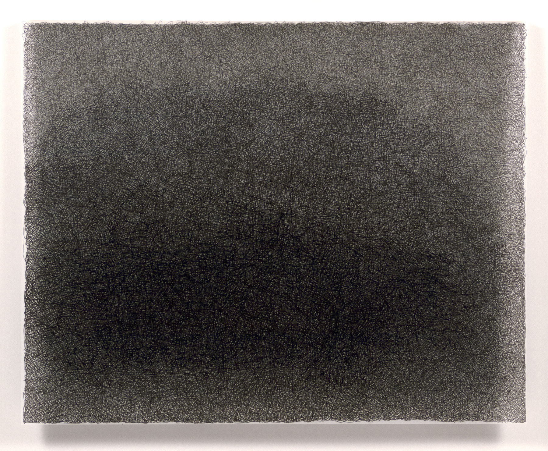 Dense field of fine, parallel horizontal lines in black and charcoal gray, creating a subtle gradation from darker tones in the center to lighter tones at the edges. The delicate crosshatching technique produces a textured, luminous surface on a rectangular composition with raw edges.