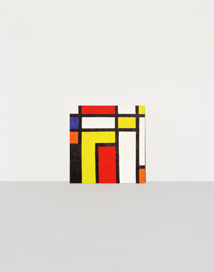 Abstract geometric composition featuring intersecting rectangular forms in red, yellow, blue, orange, and white, arranged against a neutral background in the style of modernist painting.