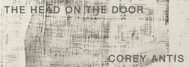 Textured abstract composition with dense crosshatching and linear marks in black and gray on a light cream ground, creating a layered, grid-like surface that suggests both materiality and image through its intricate, almost architectural patterning.