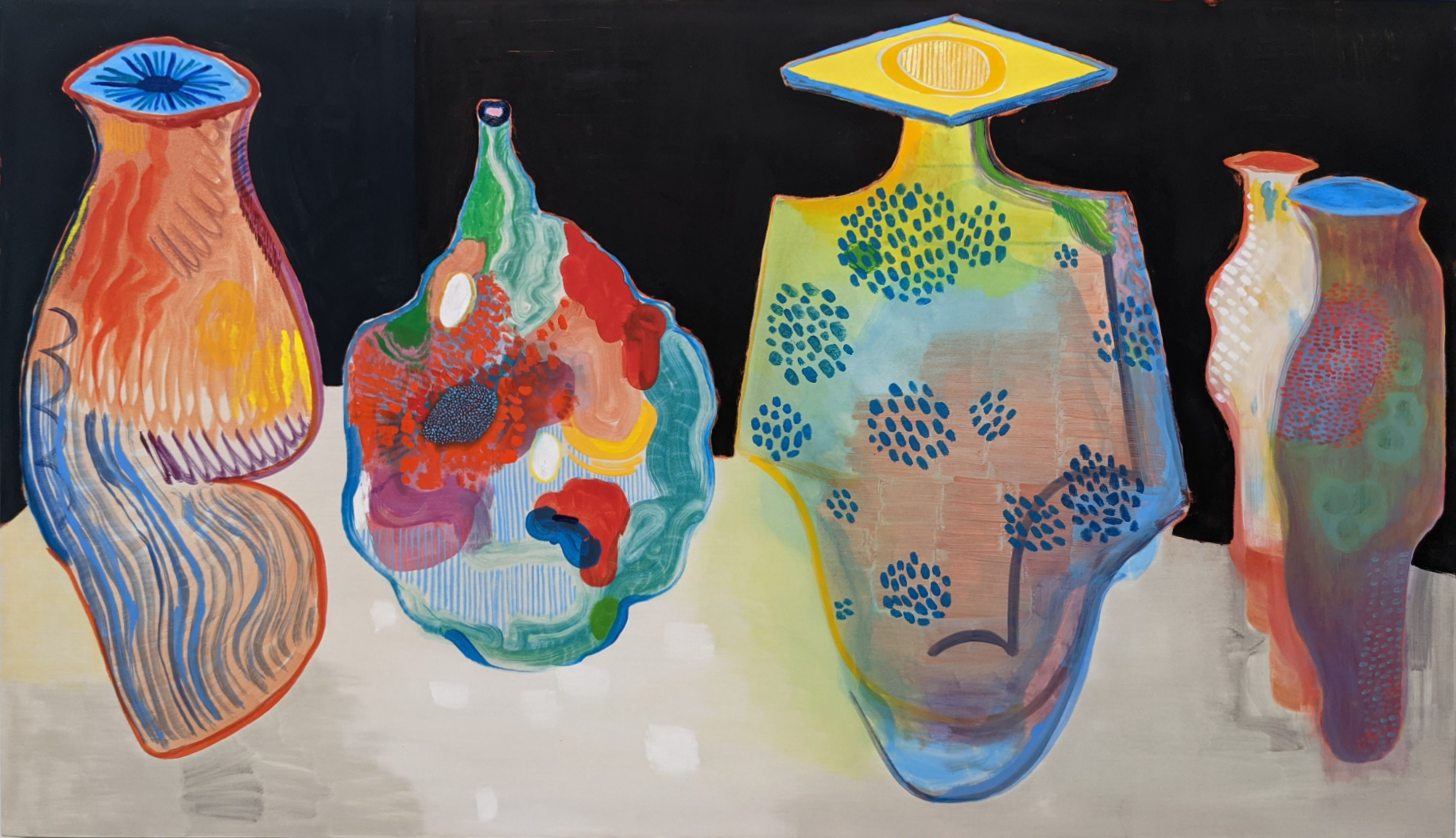 Four organic, vessel-like forms painted in vibrant colors including yellows, blues, reds, and greens, with varied surface treatments including linear patterns, dotted details, and gestural marks. The sculptural paintings feature abstract facial features and openings, displayed against a neutral background with contemplative, biomorphic qualities.