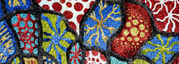 Densely layered composition of ornate baroque-inspired patterns and symbols covered entirely in multi-layered glitter in vibrant blues, reds, yellows, and golds, creating an intensely reflective and visually overwhelming surface that draws the eye despite its almost blinding luminosity.